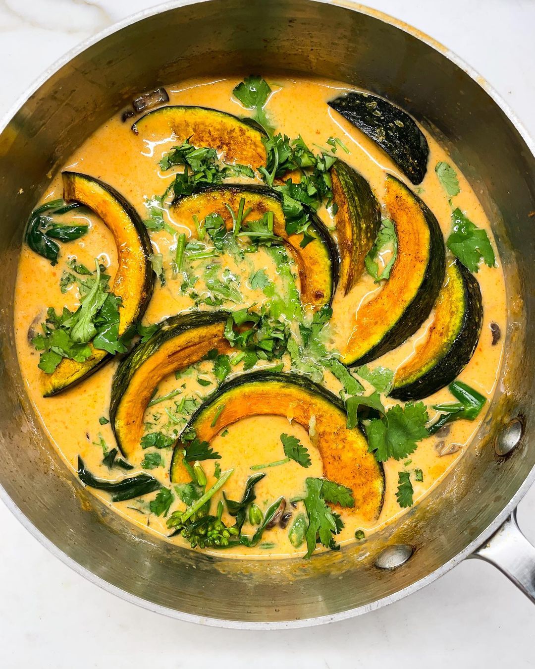  A pan filled with colorful squash and assorted vegetables, ready for cooking.