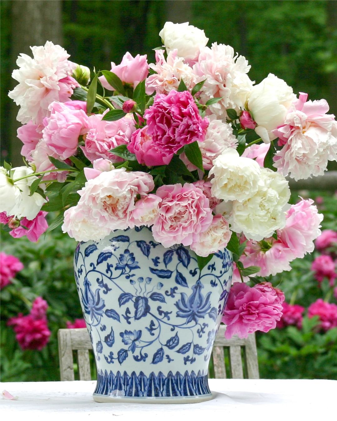 A vase filled with pink and white peonies, symbolizing beauty and grace.